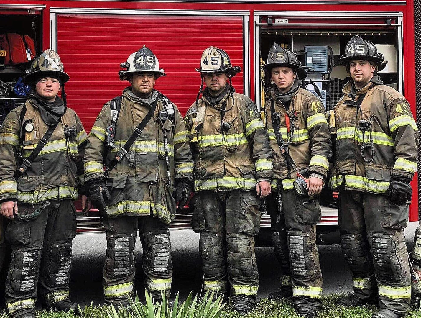 firefighters standing in front of rescue truck