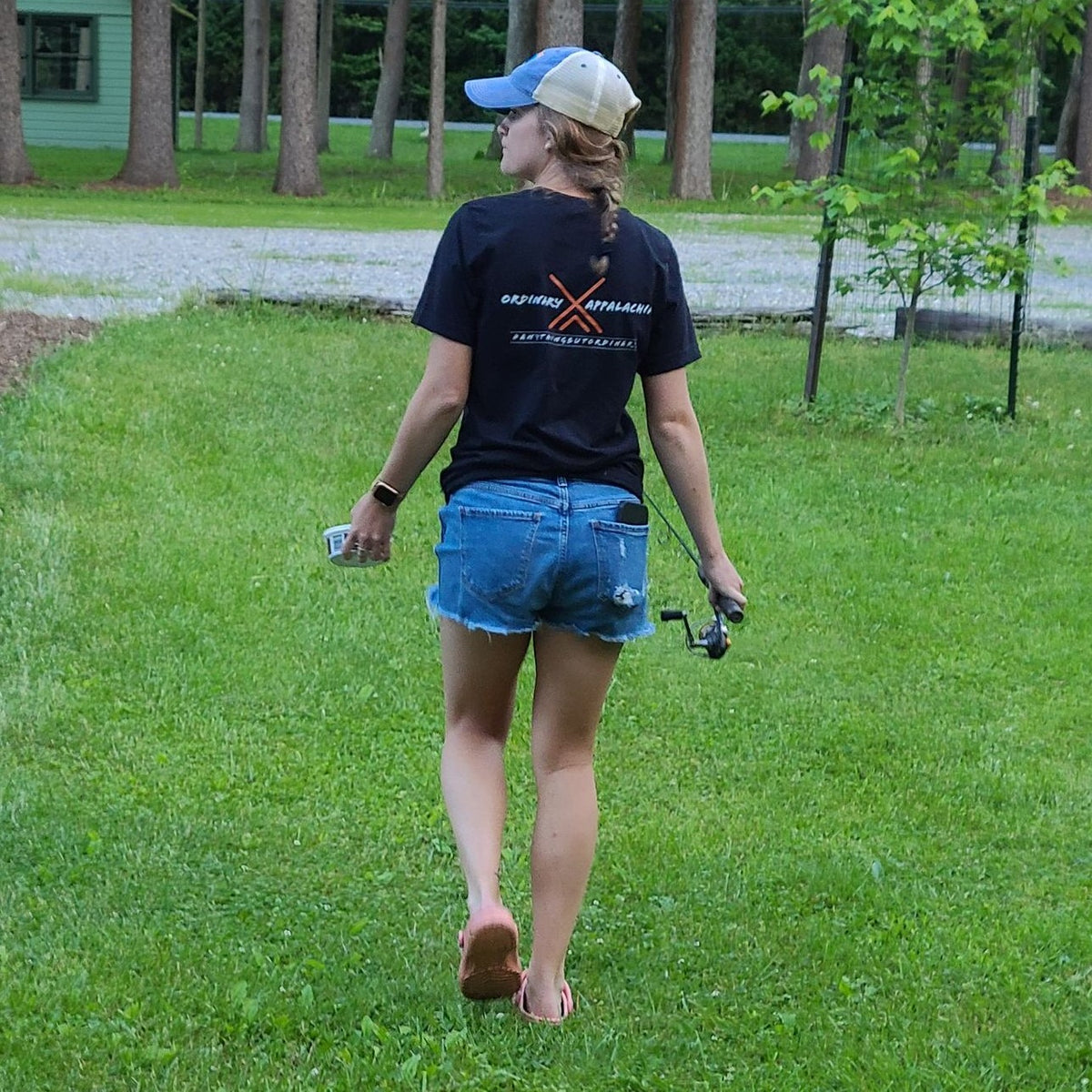 girl wearing ordinary appalachia t shirt with fishing rod